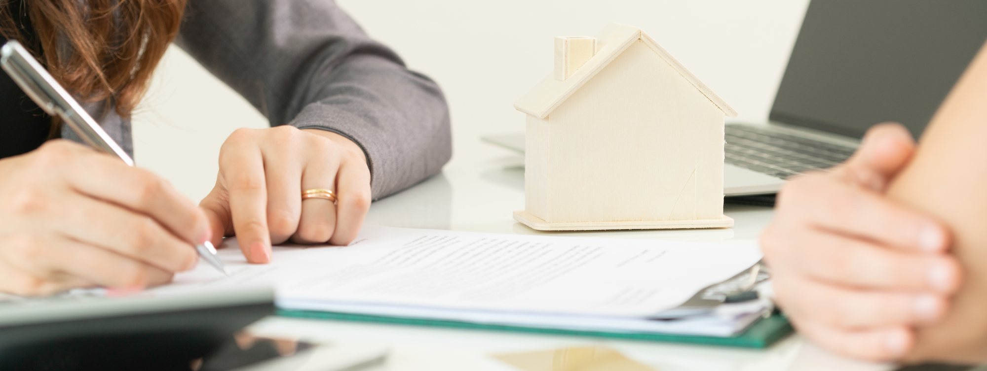 Client Signs Document to Buy House and Real Estate
